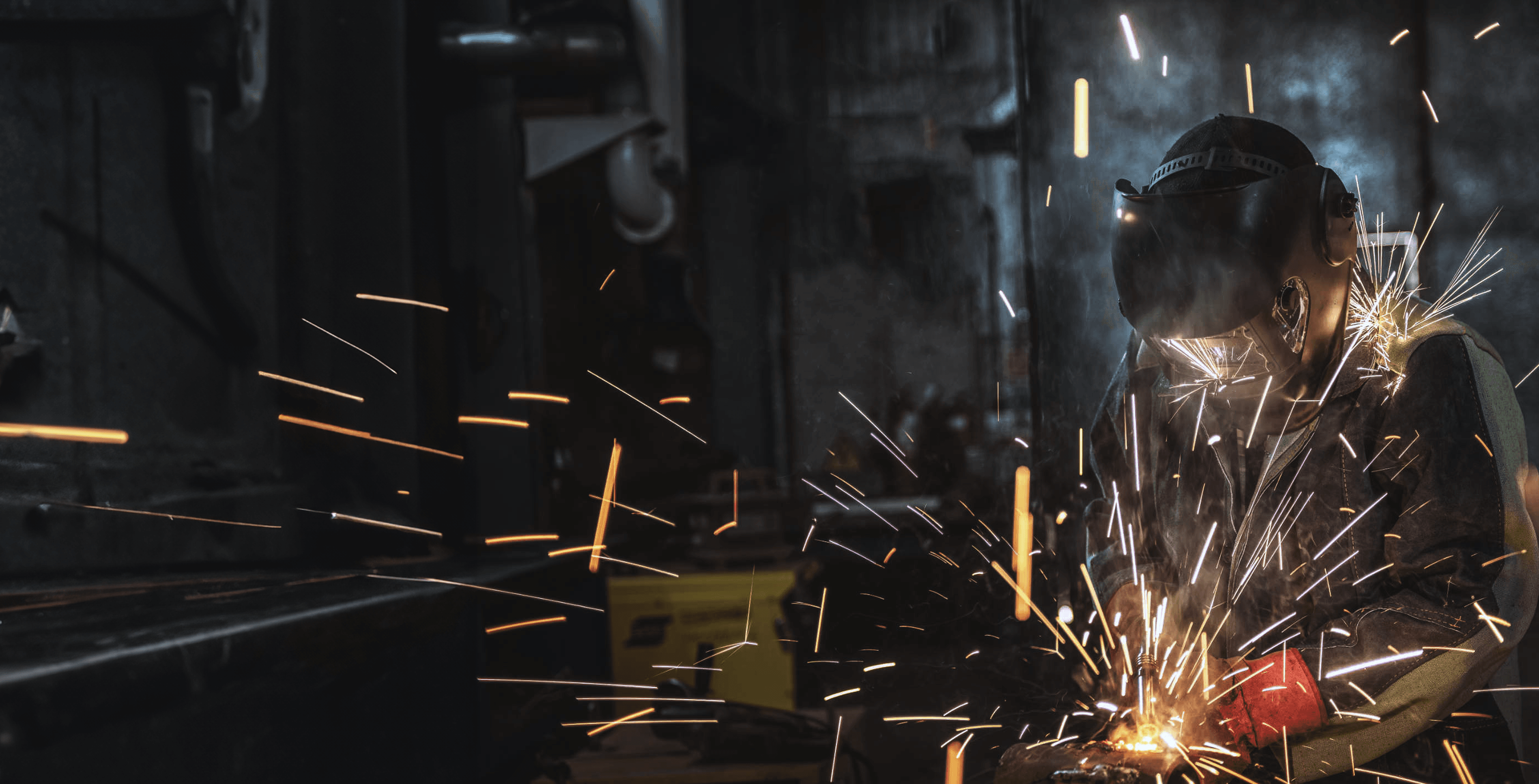 Welder creating sparks on a job site