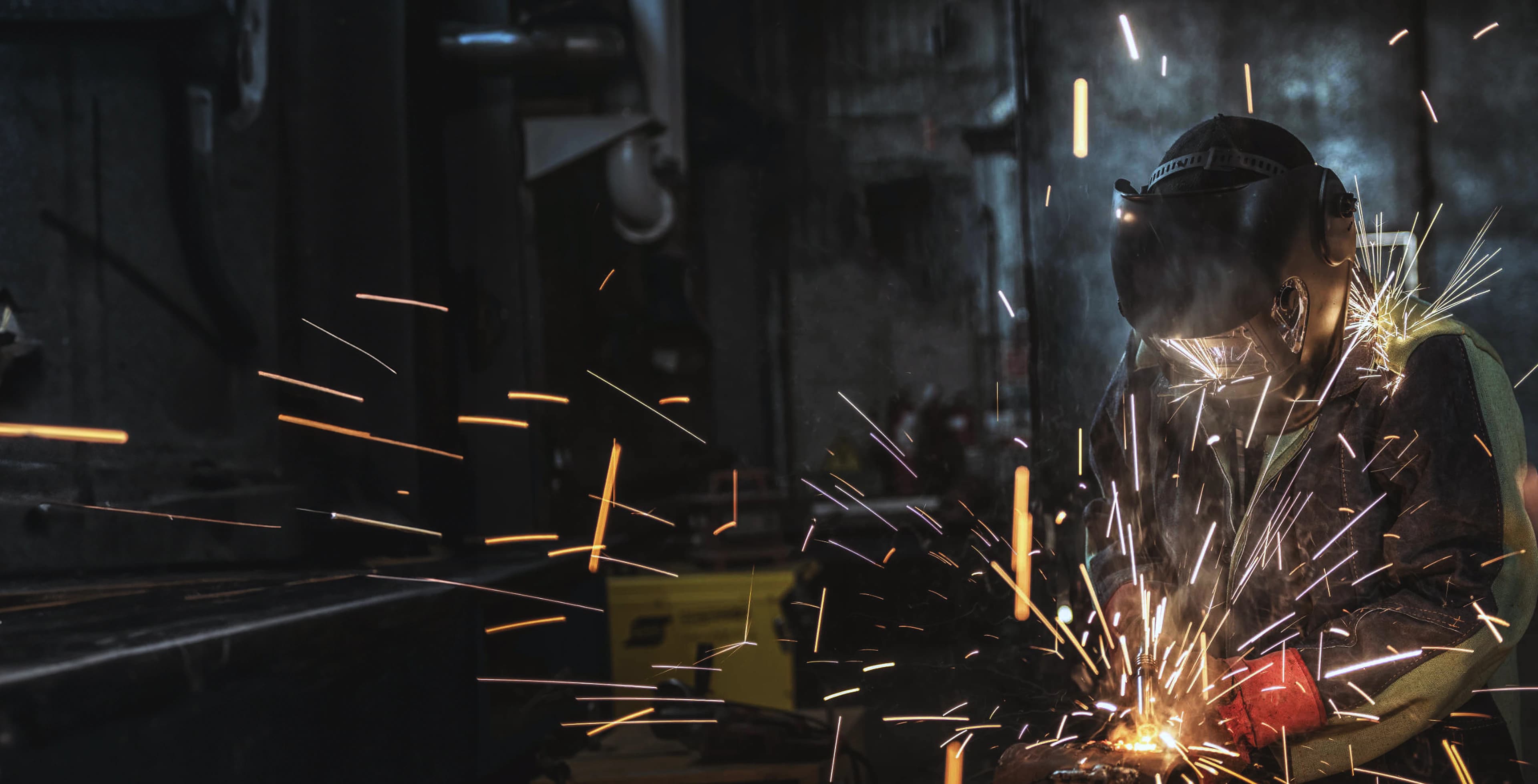 Welder creating sparks on a job site